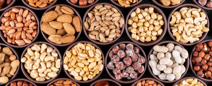 set-pecan-pistachios-almond-peanut-cashew-pine-nuts-lined-up-assorted-nuts-dried-fruits-mini-different-bowls_176474-2051